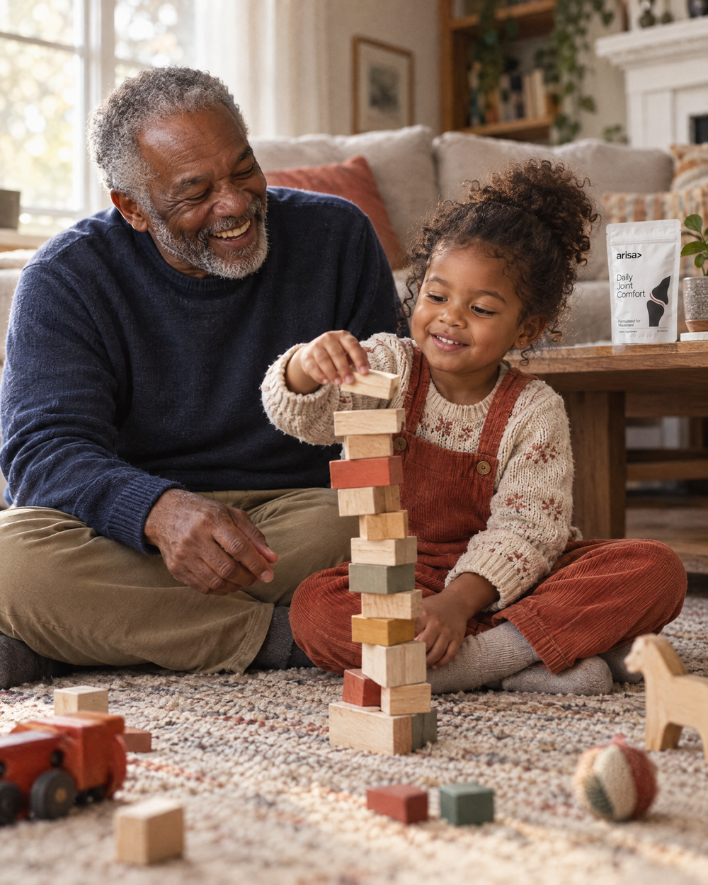 Grandfather sitting on the floor building a block tower with his granddaughter